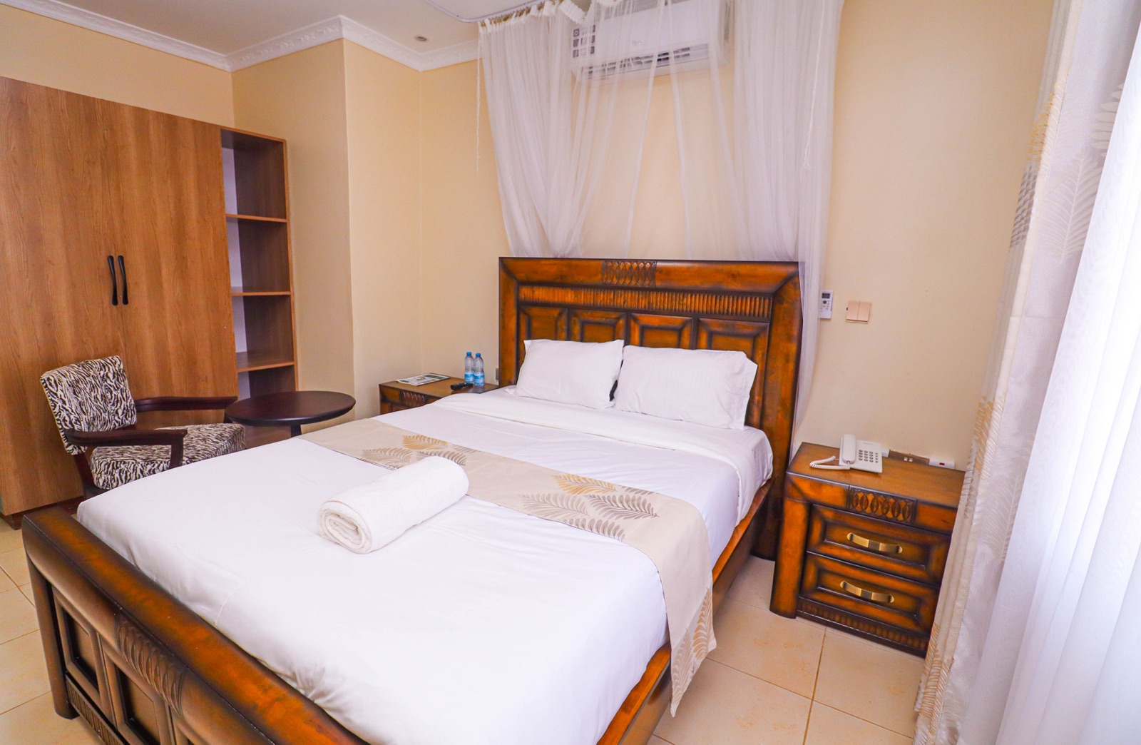 A comfortable cottage bedroom at The Westgate Inn with a neatly made king-size bed