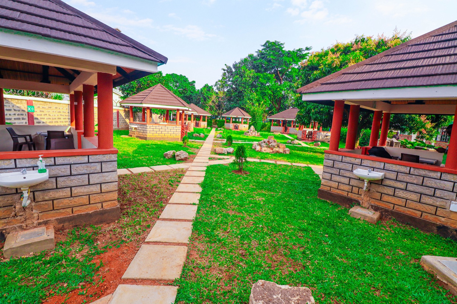 Garden gazebos among lush greenery at The Westgate Inn