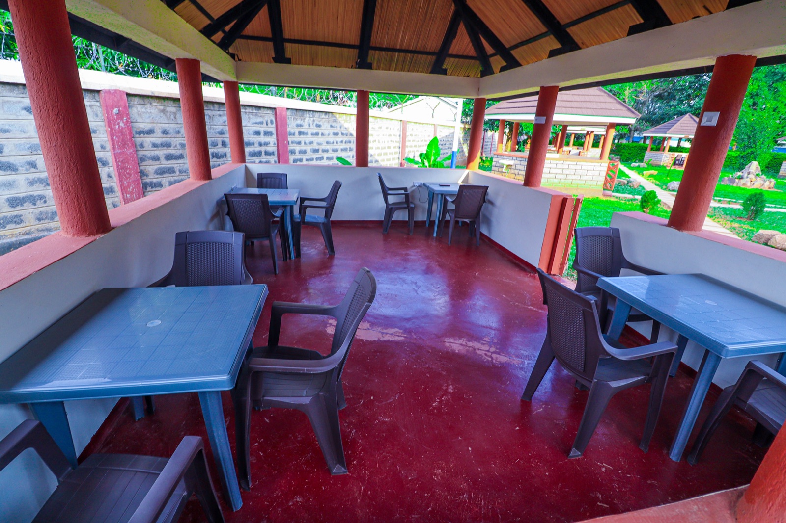 A garden gazebo at The Westgate Inn set with dining tables and chairs for a wedding reception or event